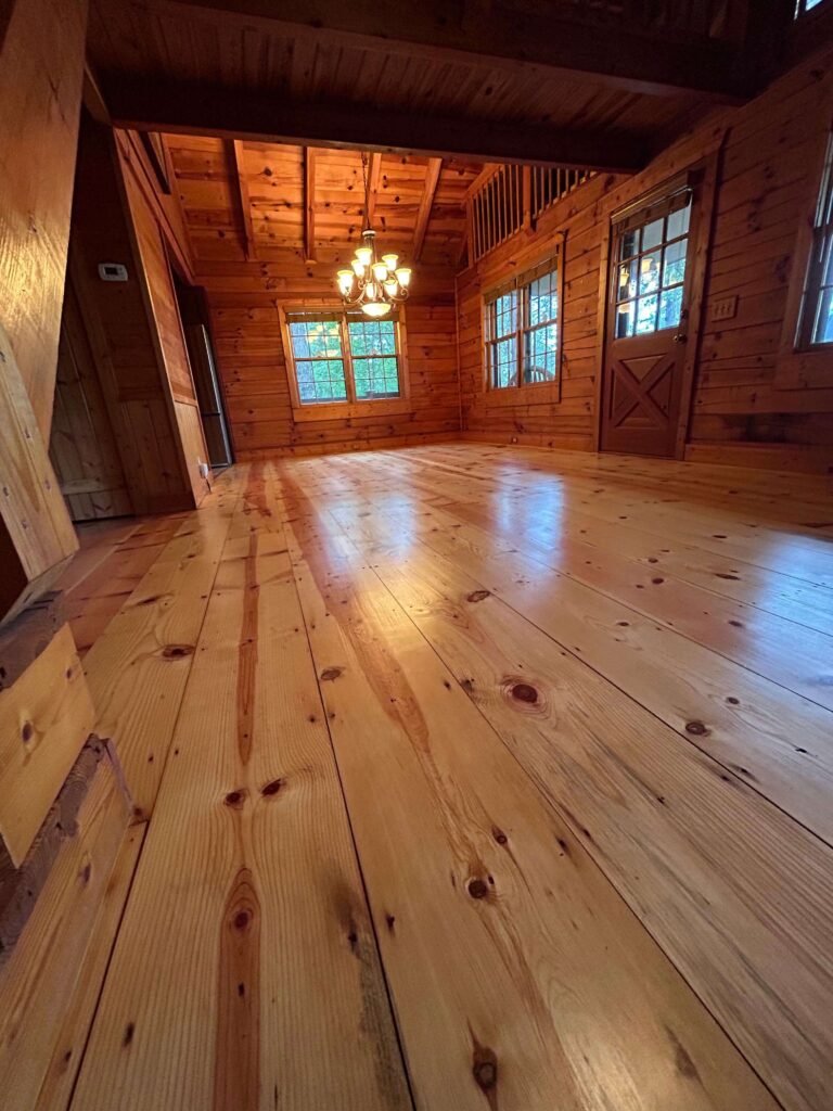 Light wood floor with visible knots in a cabin interior