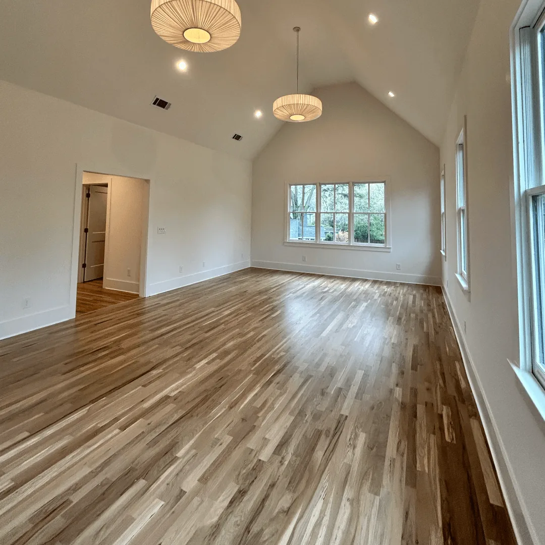 Light wood flooring in an open, bright room