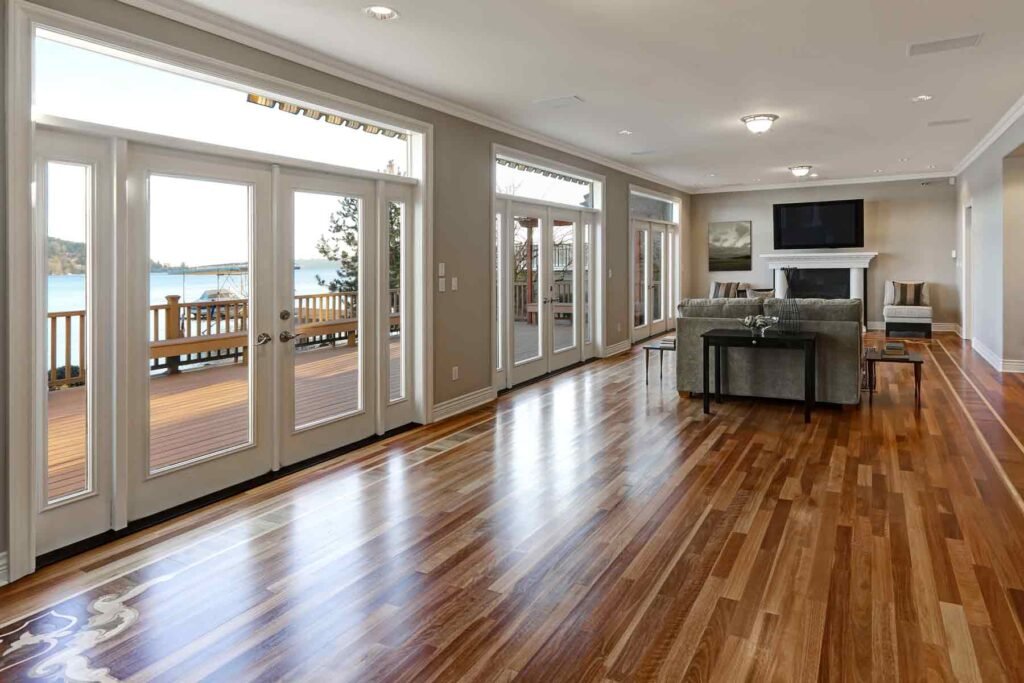 Living room with wood flooring and glass doors to a deck