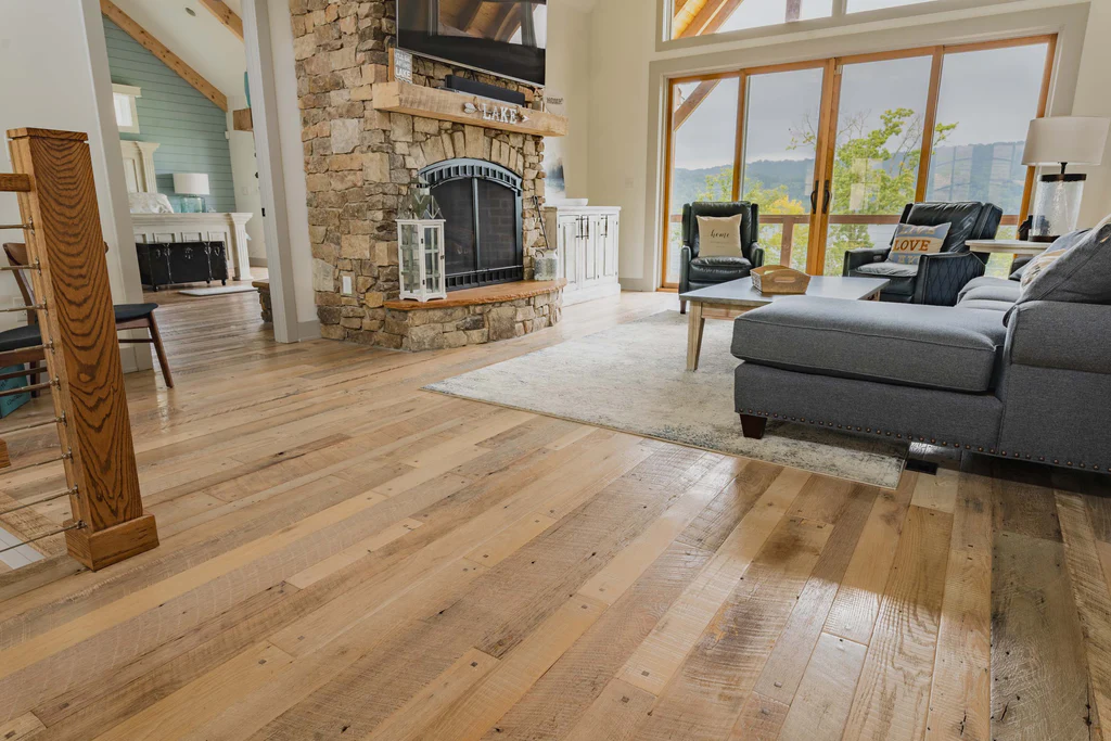 Living room with light wood flooring and stone fireplace